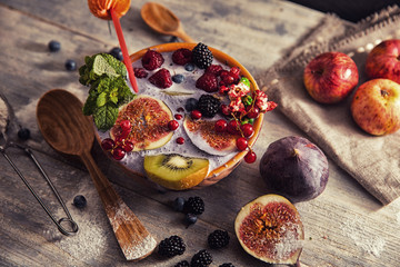 bright detox smoothie with berries on wooden background bowl