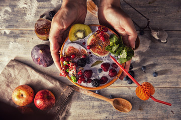 bright detox smoothie with berries on wooden background bowl
