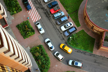 View of the courtyard of the house with parked cars..