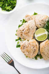Chicken breasts with parsley and citrus top view. Healthy food.