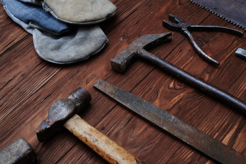 Carpentry hand tools composition over grunge wooden background