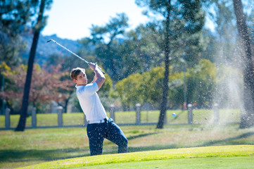 golfer playing a chip shot onto the green