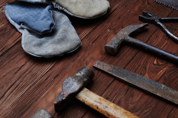 Set of different hand tools over wooden background