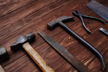 The set of old worn file and a hammer isolated on wooden grunge