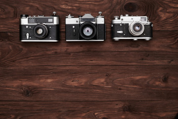 Top view of three vintage cameras with a copy space
