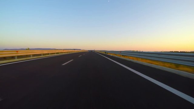 an empty road at sunset