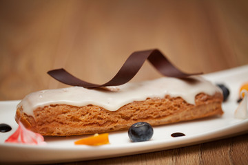Tasty piece of chocolate cake on wooden table background