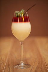Panna cotta dessert with strawberry jelly on rustic wooden background. Holiday food concept. Soft focus.
