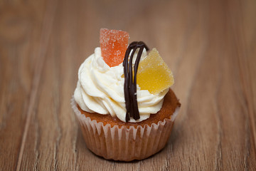 Homemade Chocolate Cupcake with chocolate frosting on wooden table