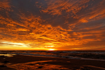 Orange sunset on the beach. Baltic Sea.