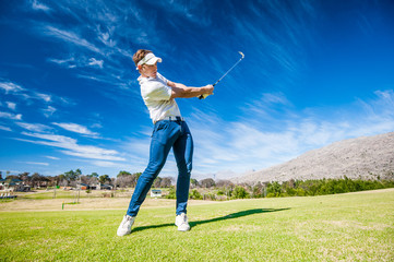 golfer playing a shot on the fairway