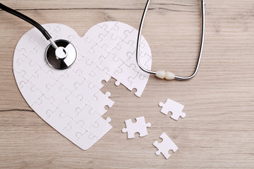 White heart shape puzzle with stethoscope