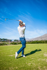 golfer playing a shot on the fairway