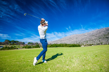 golfer playing a shot on the fairway