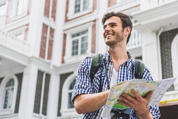 Carefree young man planning touristic route
