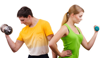 Couple exercising with dumbbells lifting weights