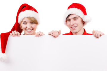 Couple with blank empty banner board. Christmas