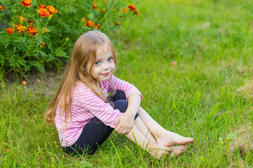 Fototapeta premium Portrait of a cute girl with long blond hair