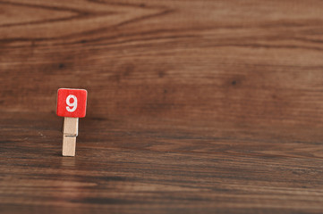 Number 9 displayed on a wooden background