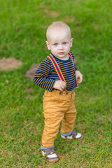 Cute little boy with big blue eyes in the park