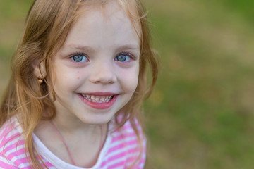 Portrait of a cute girl with long blond hair