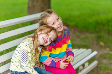 Two beautiful girlfriends posing in the garden