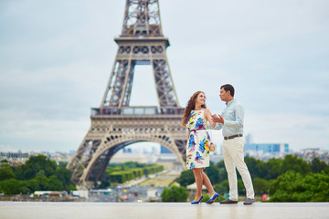 Romantic loving couple having a date near the Eiffel tower