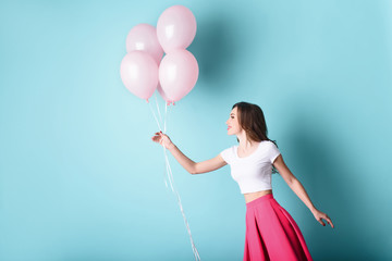 Happy young woman having fun with inflatables