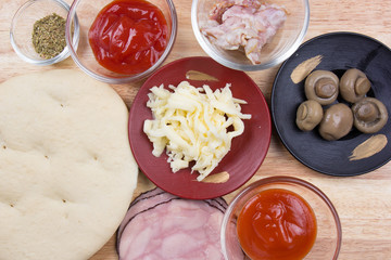Raw pizza and ingredients
