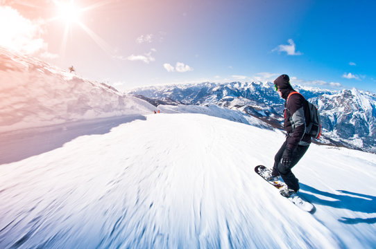 snowboarder riding fast, motion blur, fisheye shot