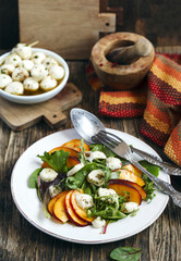Peach and marinated mozzarella salad with fresh mixed greens