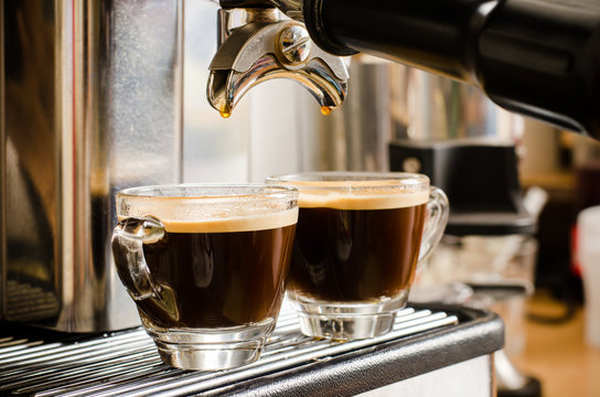 Coffee machine making espresso coffee in two cups