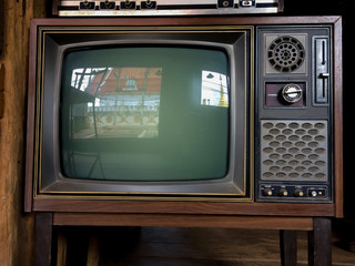 Old television with temple reflect inside.Reflection of Temple on tv screen.Television with reflection of temple and golden pagoda.