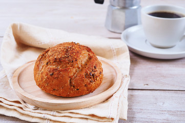 Close up of multi grain bread on a wooden plate.