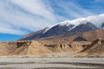 Mount Muztag Ata, the father of ice mountains, and the Karakul Lake, on the Pamirs Plateau,...