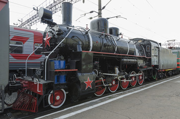 Fototapeta na wymiar Ulan-Ude, RUSSIA - July, 16 2014: Old vintage steam locomotive Ea series on the platform of Ulan-Ude station, Russia