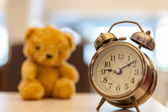 Retro Teddy Bear toy alone with alam clock.