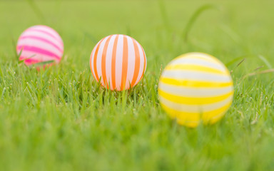 Close up young woman playing ball in the garden.Close up young woman playing colorful plastic balls for kid activity.