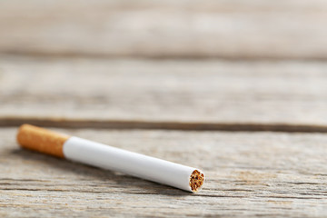 Tobacco cigarette on a grey wooden table
