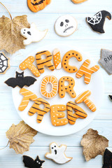 Fresh halloween gingerbread cookies on blue wooden table