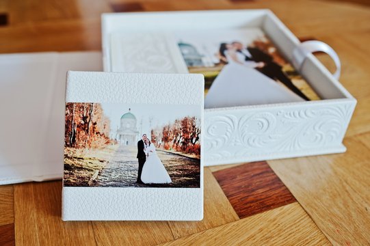 White leather wedding book or wedding album on wooden background