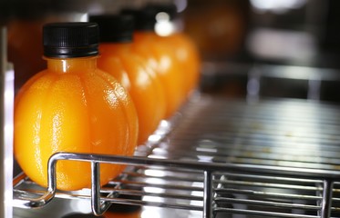 orange juice in circle bottle 