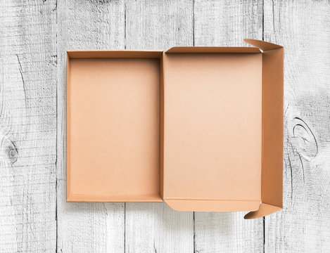 Open cardboard box top view on wooden background