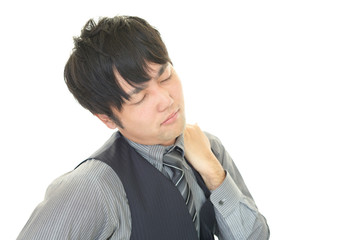 肩こりを訴えるビジネスマン