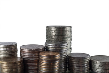 The isolated vertical piles of different coins on a white background