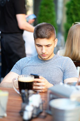 Man with mobile phone in restaurant