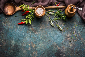 Rustic Cooking background with wooden spoon,fresh herbs and spices, top view