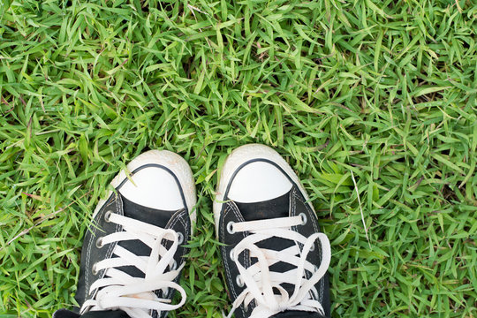 black sneakers on green grass