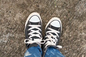 Black Sneakers shoes on road concrete