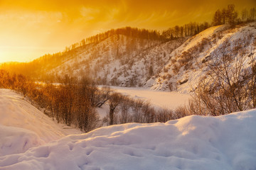 Fab winter landscape. Sunset on river covered snow. Kemerovo reg